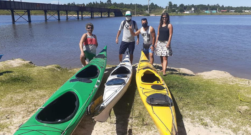 Cuatro personas posando junto a tres Kayak, de fondo se encuentra el Arroyo Solís Chico. .